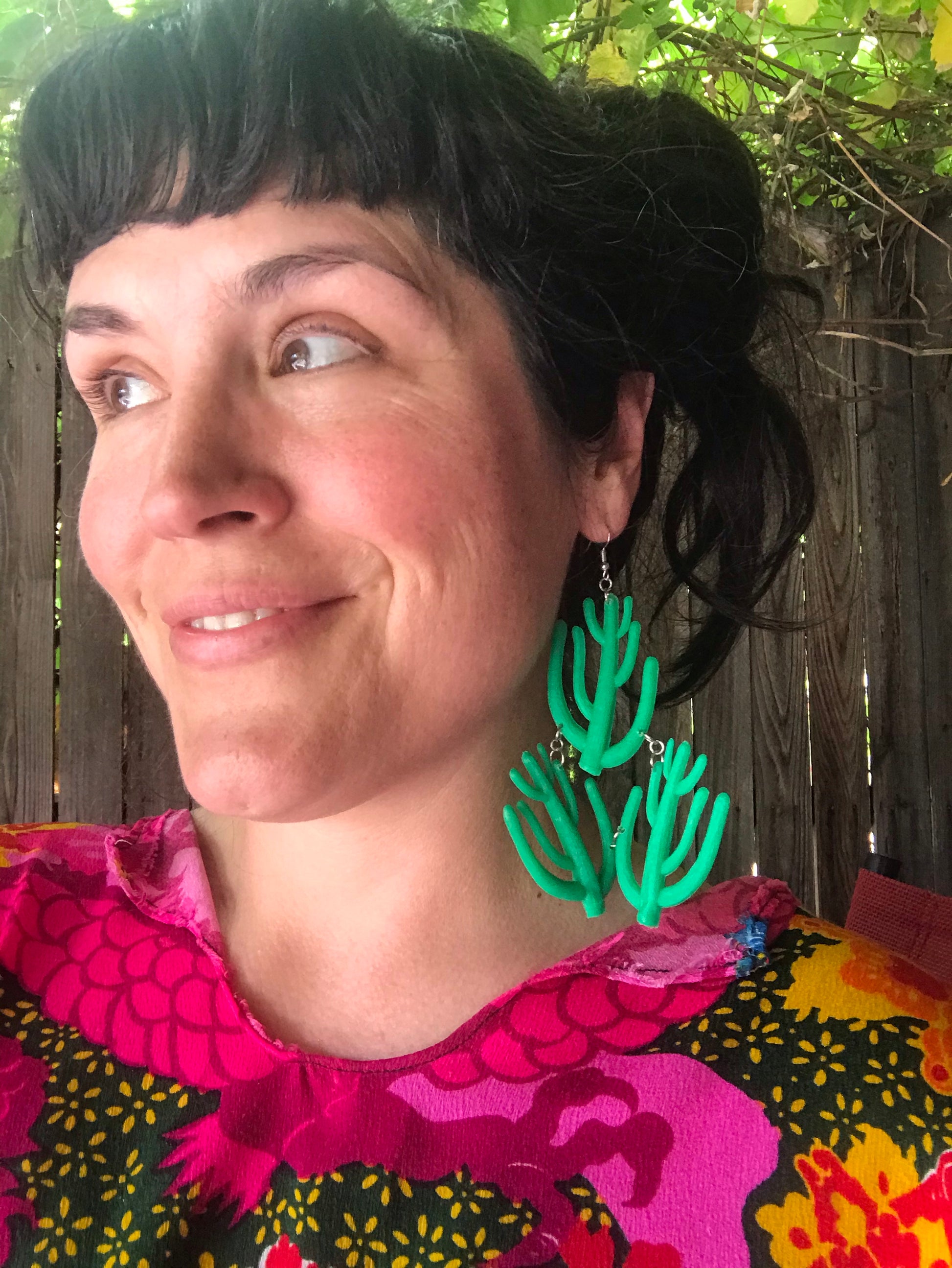 Model is wearing a bright colored caftan that compliments our Giant Cacti earrings perfectly!