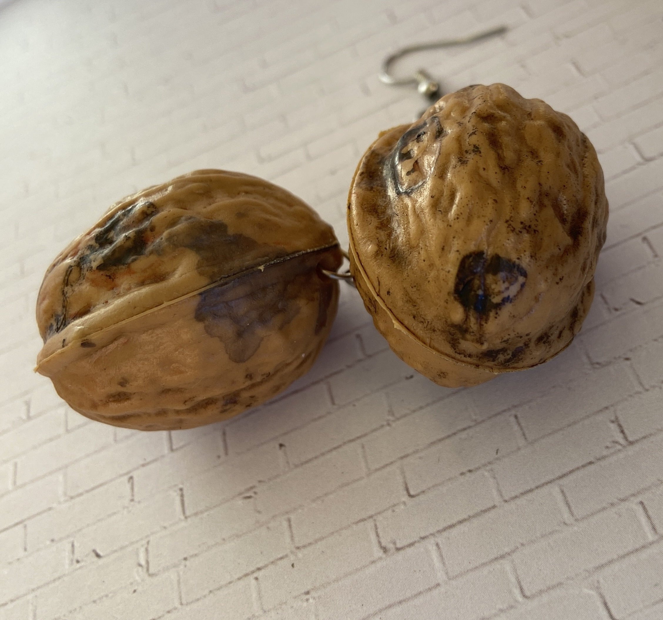 A pair of vintage plastic walnuts.
