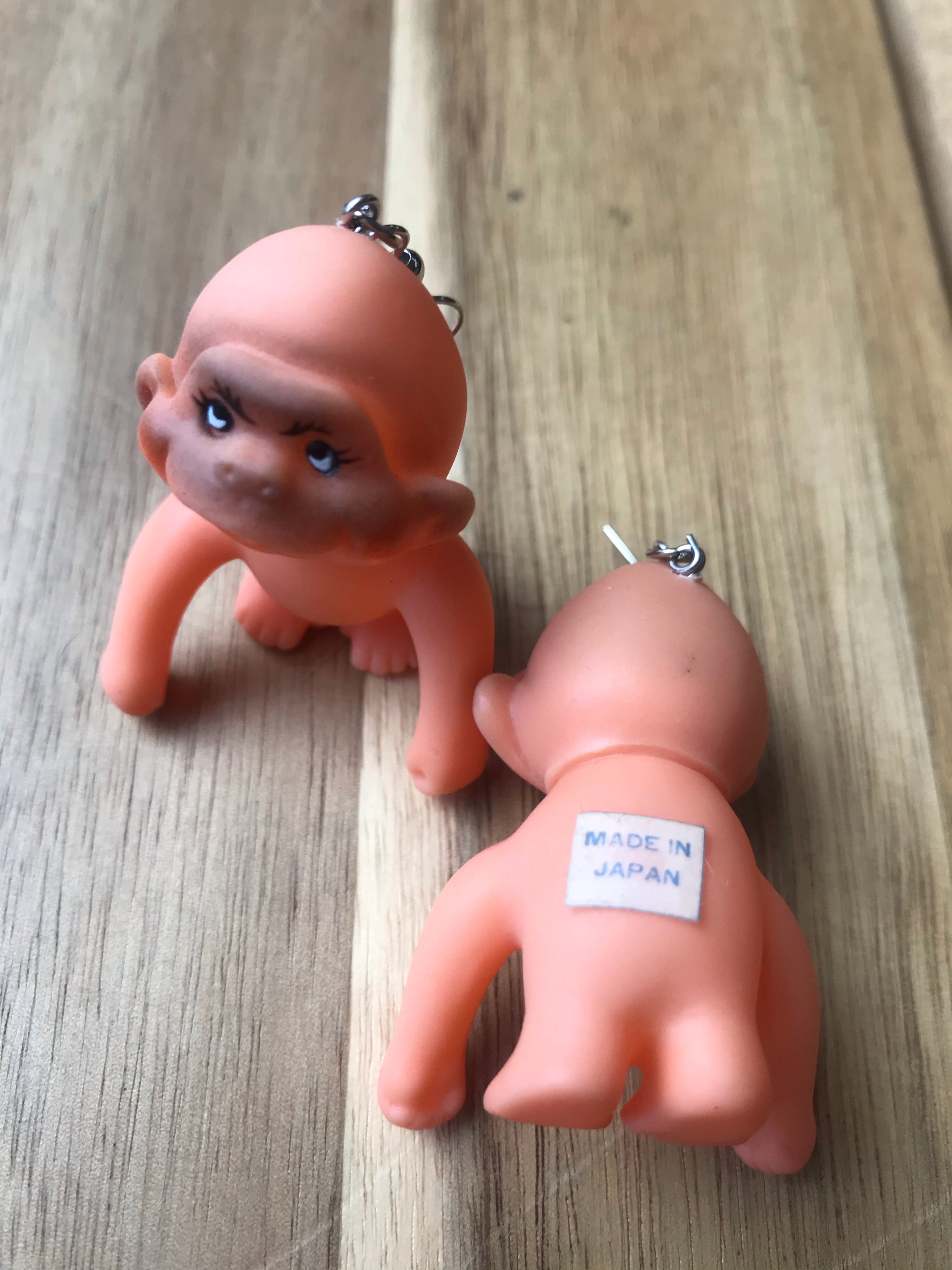 Closeup of vintage monkey dolls.  Sticker on back stating MADE IN JAPAN.