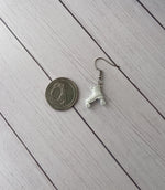 Petite rollerskate earrings resting next to a quarter.  The skate is smaller than the quarter.
